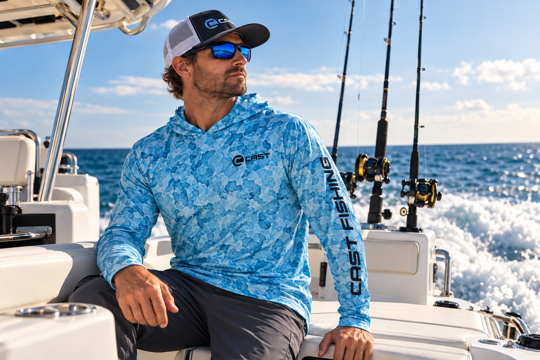 Man seated aboard a boat underway in the Aqua Camo BreezeTec hooded shirt