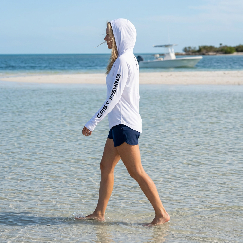 Woman in the White BreezeTec shirt with the hood up, side view